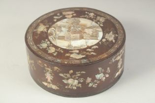 A CHINESE MOTHER OF PEARL INLAID HARDWOOD CIRCULAR BOX, inlaid all over with precious objects and