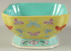 A CHINESE FAMILLE JAUNE PORCELAIN SQUARE-FORM BUTTERFLY BOWL, the base with Jiaqing mark, 15cm at
