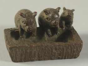 A BRONZE OKIMONO OF PIGLETS AT A TROUGH, 5cm wide.