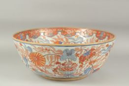 A LARGE IMARI PORCELAIN PUNCH BOWL, painted with flora and gilt highlights, character mark to