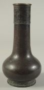 A 19TH CENTURY BRONZE VASE, the neck with archaic-type decorative band, 23cm high.