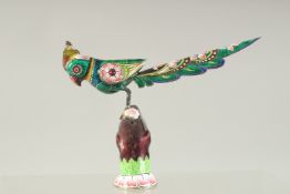A FINE EARLY 20TH CENTURY INDIAN ENAMELLED SILVER PARROT, inlaid with small rubies, 14cm long.
