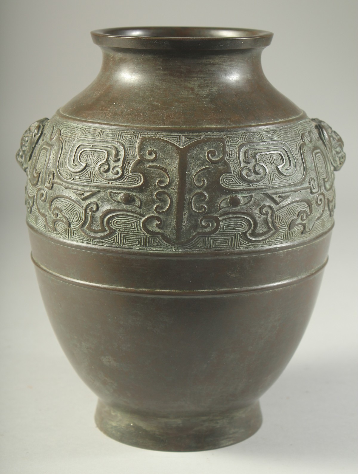 A CHINESE BRONZE VASE, with a band of archaic design and twin beast-head handles, 22cm high. - Image 3 of 6