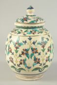 A FINE 19TH CENTURY OTTOMAN TURKISH KUTAHIYA LIDDED JAR, with floral decoration, 25cm high.