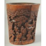 A CHINESE CARVED BAMBOO BRUSH POT, relief decorated with figures, 19cm high.