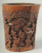 A CHINESE CARVED BAMBOO BRUSH POT, relief decorated with figures, 19cm high.