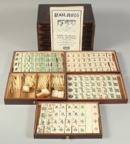 A CHINESE BOXED MAHJONG SET, with bone gaming counters inside five opening drawers.