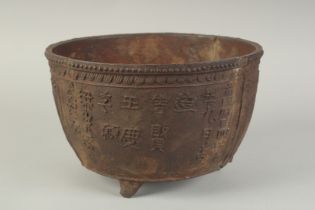 AN EARLY MING CAST IRON CENSER, with script and lotus decoration, raised on three feet, 29cm