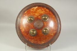 A 18TH CENTURY NORTH INDIAN SHIELD, made of animal hide -possibly rhinoceros, and mounted with