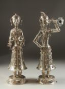 A FINE PAIR OF 19TH CENTURY INDIAN SILVER FIGURES OF MUSICIANS, 30cm high.
