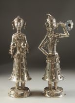 A FINE PAIR OF 19TH CENTURY INDIAN SILVER FIGURES OF MUSICIANS, 30cm high.