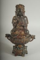 A CHINESE BRONZE SEATED DEITY LIDDED CENSER, the censer of lotus form, with traces of gilt