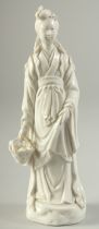 A BLANC DE CHINE PORCELAIN FIGURE, the lady holding a fish in a basket with fine details, 16cm