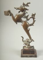 17TH-18TH CENTURY SOUTH INDIAN BRONZE FIGURE OF YALI, mounted to a wooden base, 14cm high.