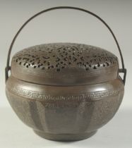 A CHINESE METAL HAND WARMER, with pierced cover, 15cm diameter.