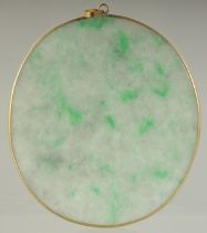 AN EARLY 20TH CENTURY JADEITE OVAL PENDANT, 6cm x 5cm.