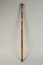 A CHINESE BAMBOO WALKING STICK, carved with monkeys, 75cm long.