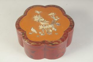 A JAPANESE MOTHER OF PEARL INLAID PETAL-FORM LACQUER BOX, the lid beautifully decorated with