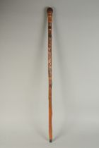 A CHINESE BAMBOO WALKING STICK, carved with bird, dragon, and a female figure, 89cm long.