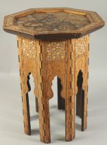 A 19TH CENTURY SYRIAN MOTHER OF PEARL AND INLAID WOODEN OCTAGONAL TABLE, the table top with