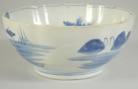 AN EARLY 20TH CENTURY JAPANESE BLUE AND WHITE PORCELAIN BOWL, the interior with landscape scene,