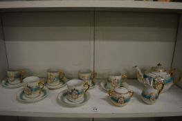 A child's six place porcelain tea service including six miniature metal spoons.