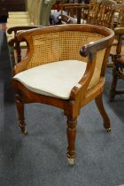 A Victorian mahogany framed bergere style desk chair.