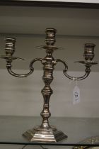 A cast silver three light twin branch candelabra with detachable top section.