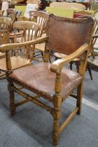 An oak and leather upholstered armchair.