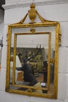 An Adam Revival gilt framed pier mirror with urn finial.