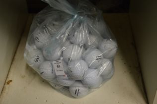 A bag of fifty Dunlop golf balls.