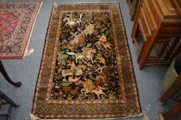 A good Persian rug, rich blue ground decorated with a hunting scene, 155cm x 94cm.