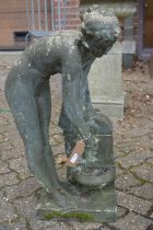 A reconstituted stone garden water feature modelled as a young maiden at a well.