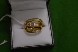 A suite of three 18ct gold and diamond rings.