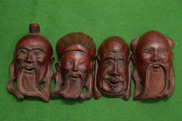Four small Chinese carved wood masks.