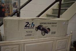 A childs metal racing car, boxed, appears unused.