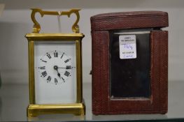 A French brass carriage clock with leather travelling case.