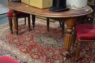 A 19th century mahogany extending dining table with one leaf on turned and reeded legs.