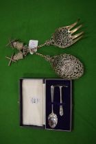 Silver spoon and pusher, cased together with a pair of Dutch white metal serving spoon and fork with