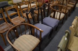 A pair of horseshoe shaped elbow chairs and a pair of Victorian dining chairs.