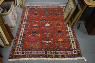A Persian design carpet, red ground with stylised decoration, 195cm x 145cm.