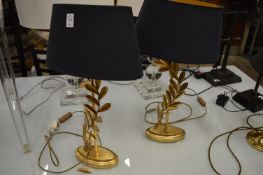 A pair of gilt metal table lamps.