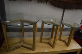 A graduated set of three glass and oak occasional tables.
