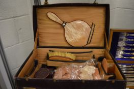 Leather dressing case with various collectables.