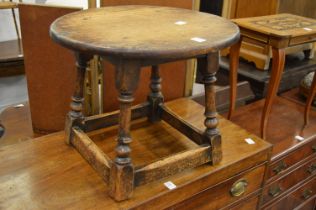 An oak circular occasional table.