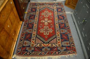 A Persian design rug, red ground with stylised decoration, 202cm x 123cm.