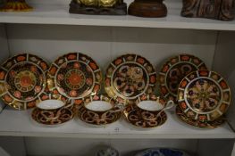 Two pairs of Royal Crown Derby Imari plates, three similar smaller plates and three cups and