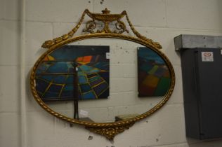 An Adam Revival gilt framed oval wall mirror.