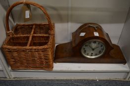 A walnut mantle clock and a wicker four bottle carrier.