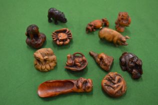 A collection of carved hardwood netsukes.